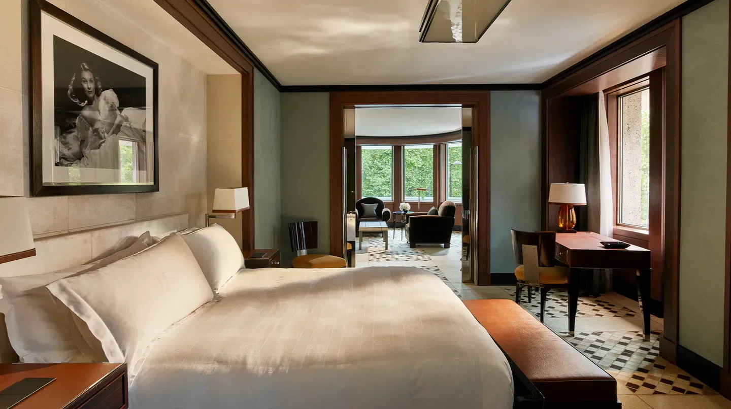 Luxury bedroom at 45 Park Lane hotel in London, featuring artwork and cozy seating.