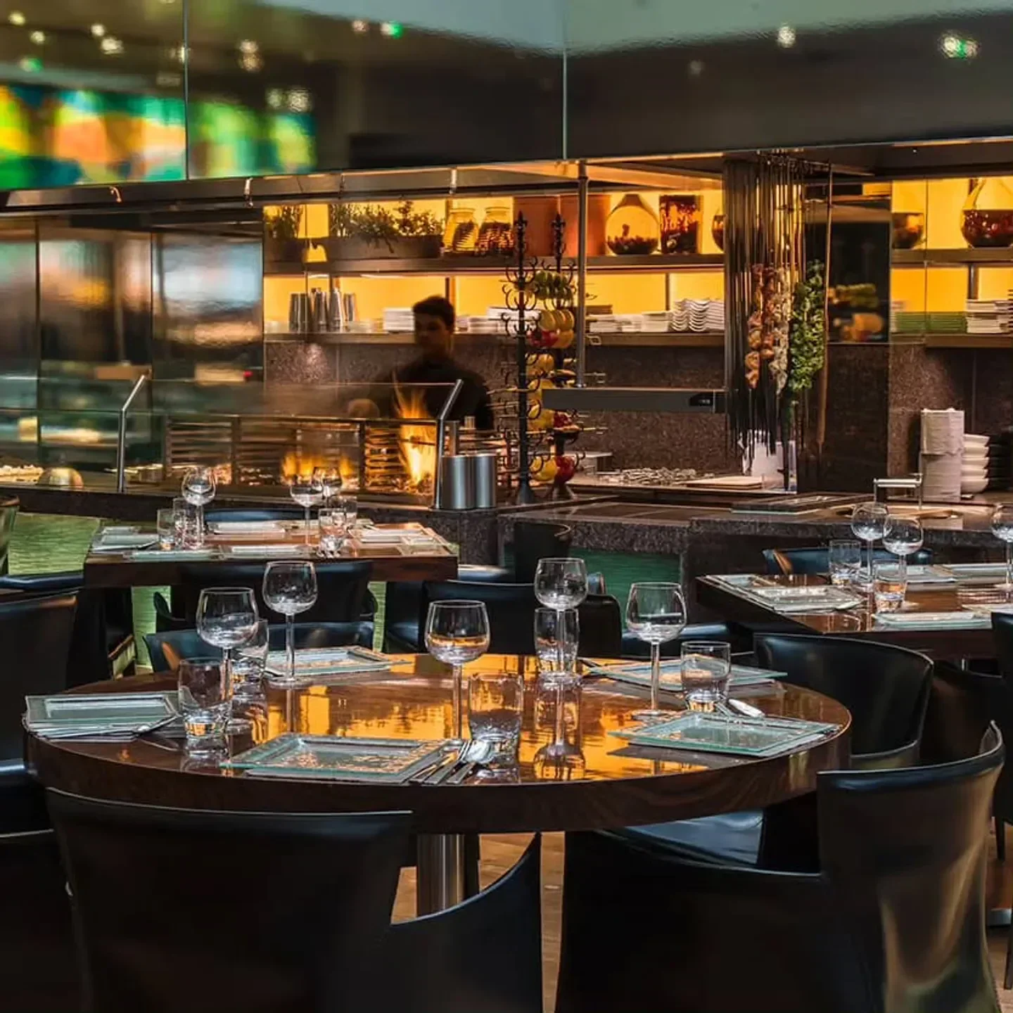 Interior of Amaya restaurant in London, showing elegant tables and open kitchen
