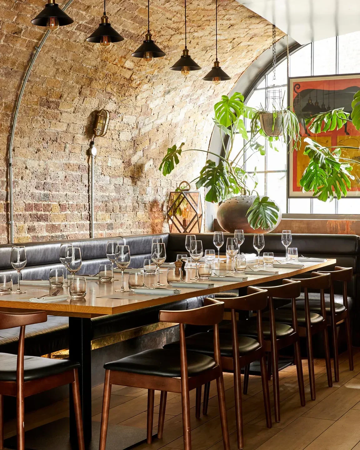 Interior of Barrafina restaurant in London, with elegant table setting and brick wall.