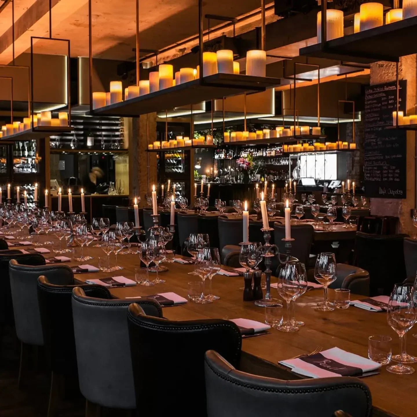 Candlelit dining table at Beast restaurant in London, with elegant setup for dinner service.