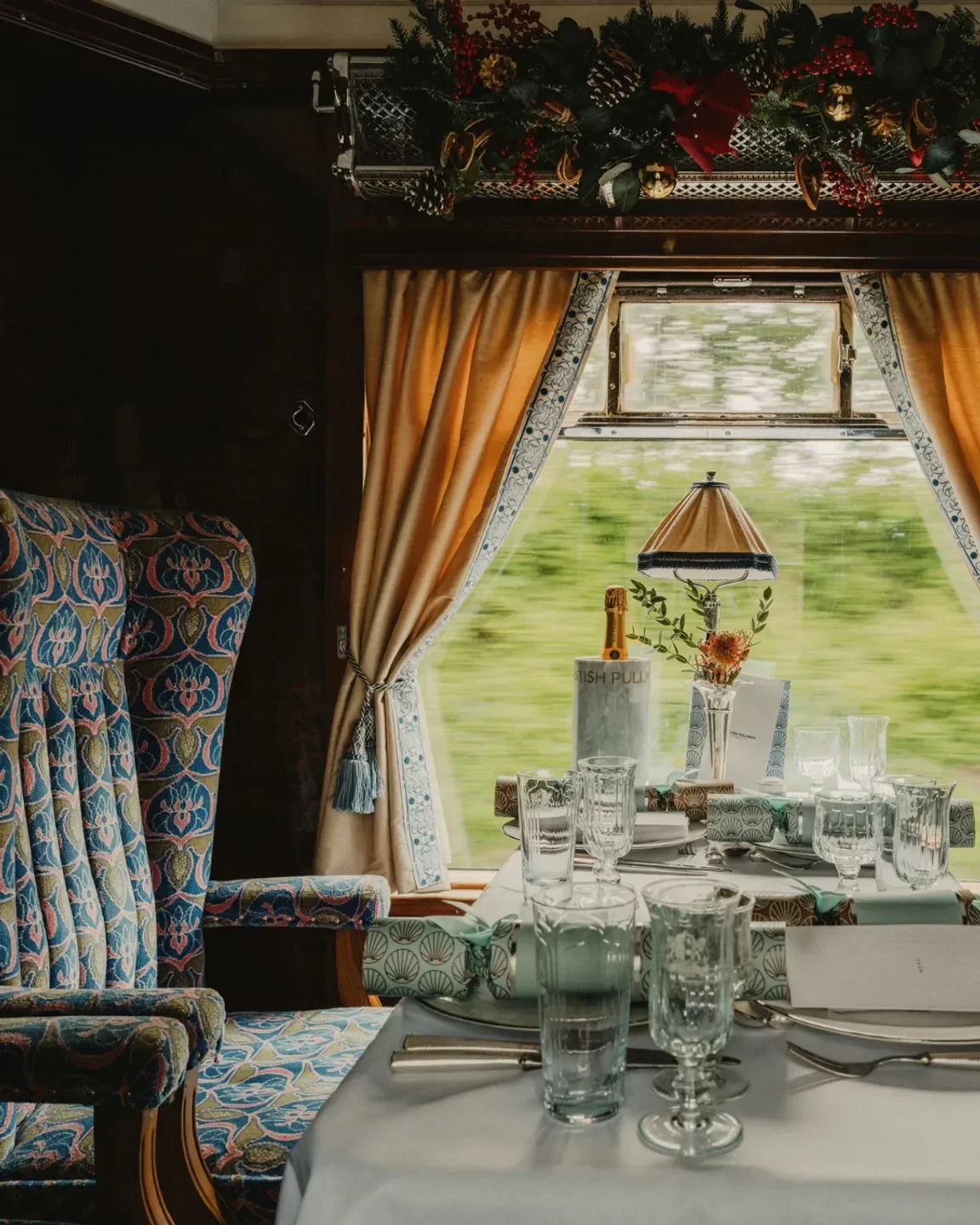 Dining car interior on the Belmond British Pullman train in London, festive table setting.