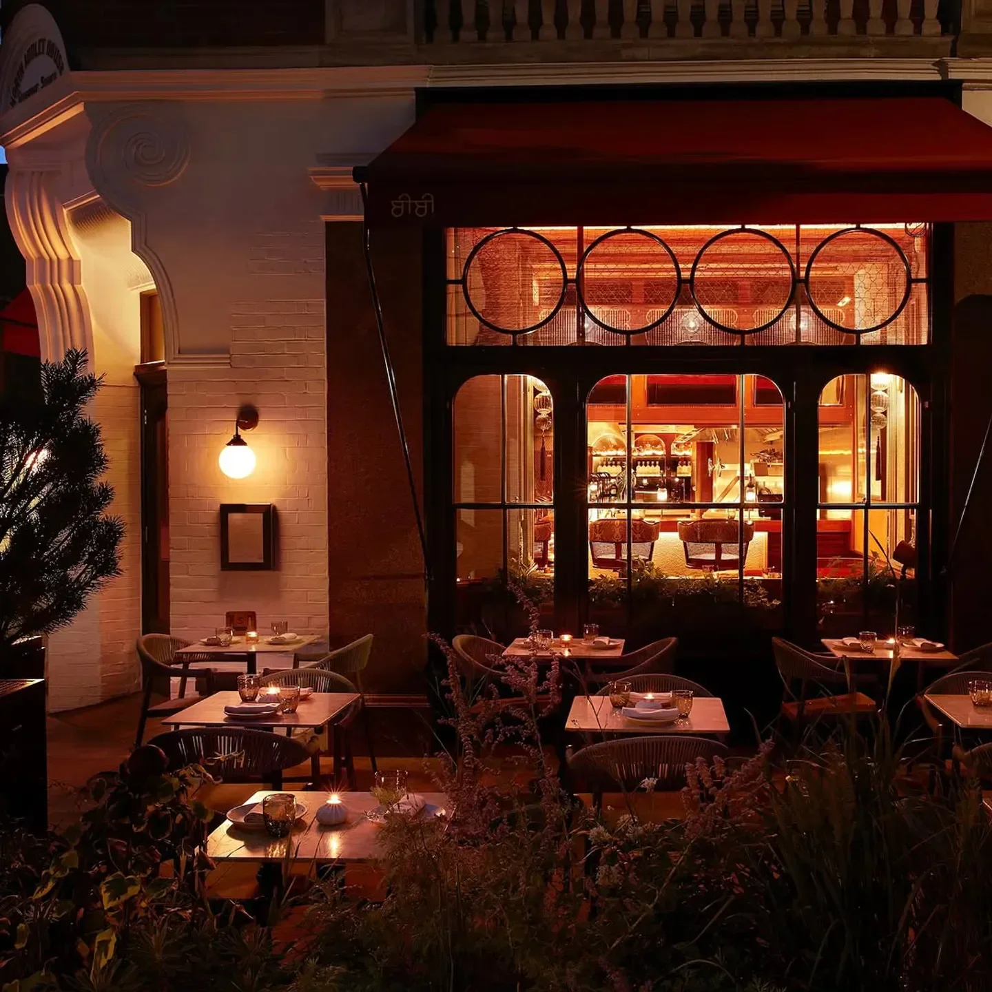 Cozy outdoor dining at BiBi restaurant in London, with warm lighting and inviting atmosphere.