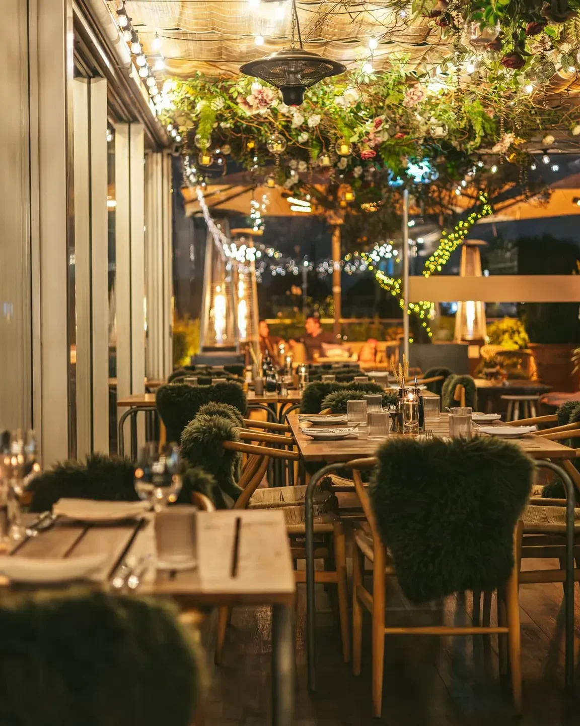 Cozy dining area at Boundary Rooftop restaurant in London, with floral decor and soft lighting