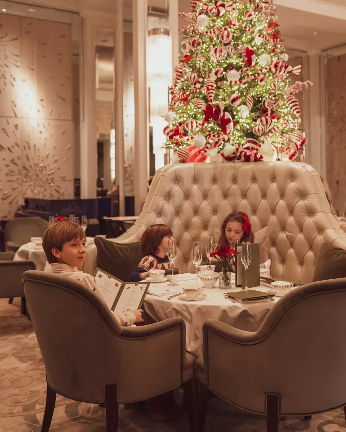 Festive holiday dining at Chez Roux London, featuring a Christmas tree and family.