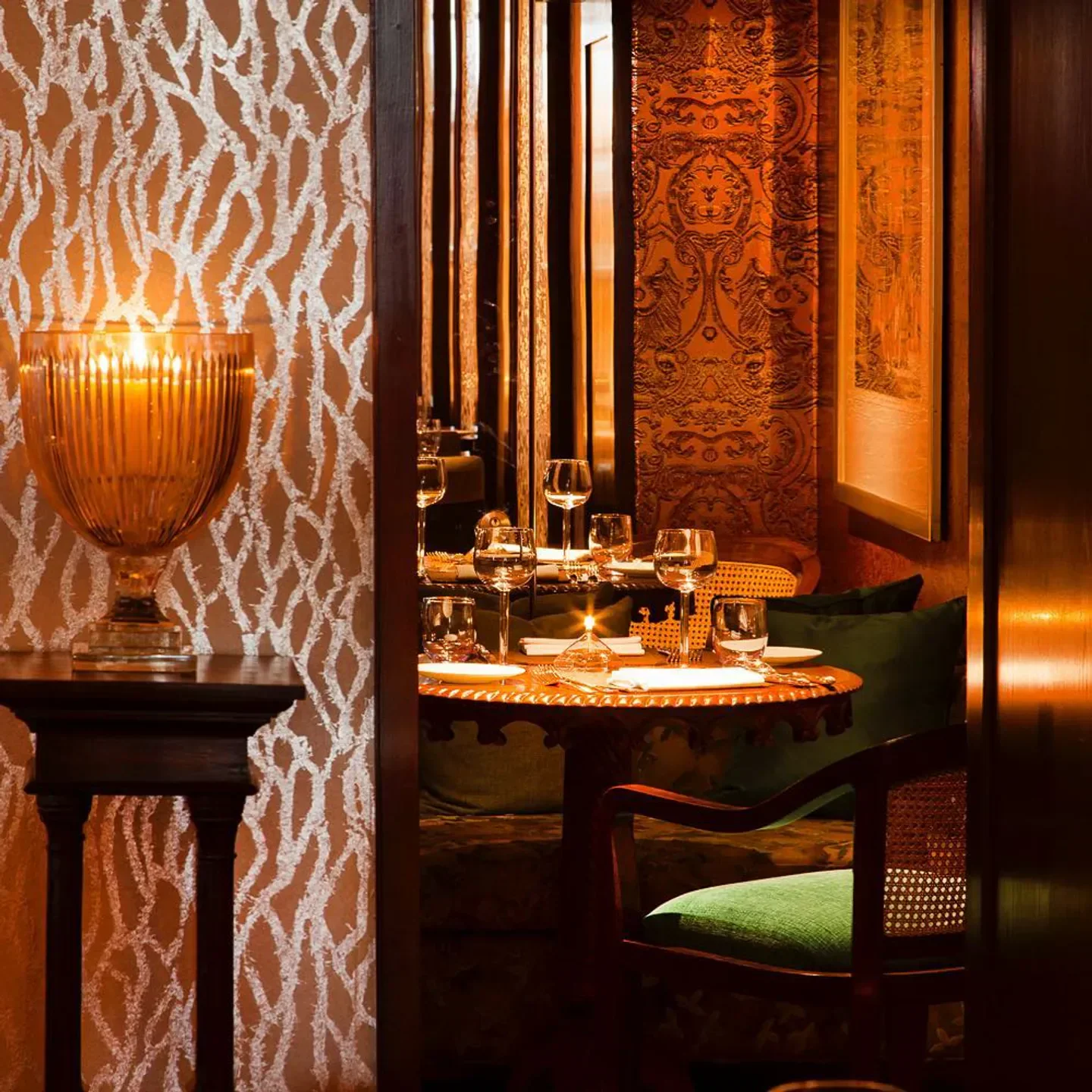 Cozy dining setting at Chutney Mary restaurant in London, with candlelit table and elegant decor