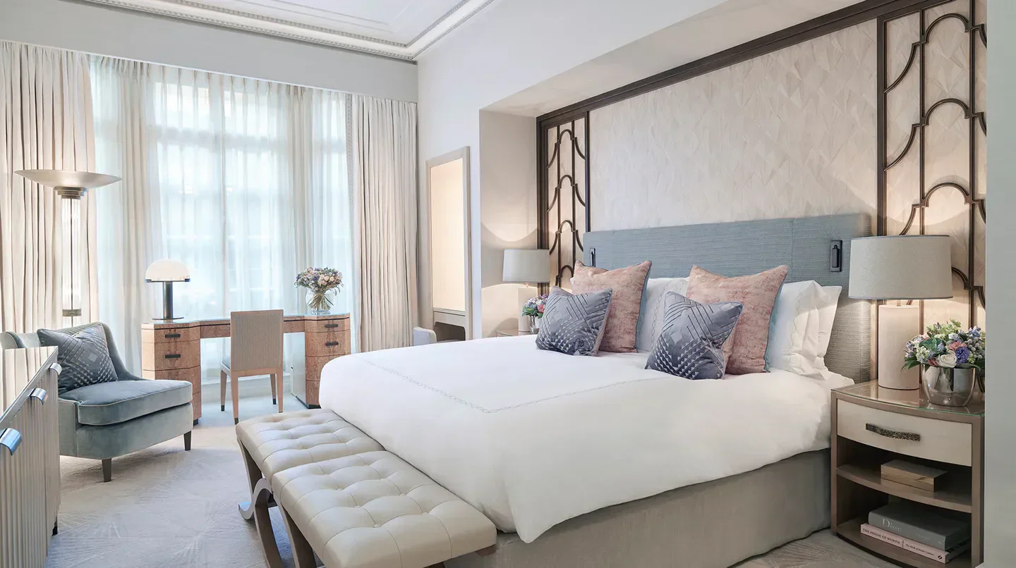 Elegant bedroom at Claridge's Hotel in London, featuring a luxurious bed and decor.