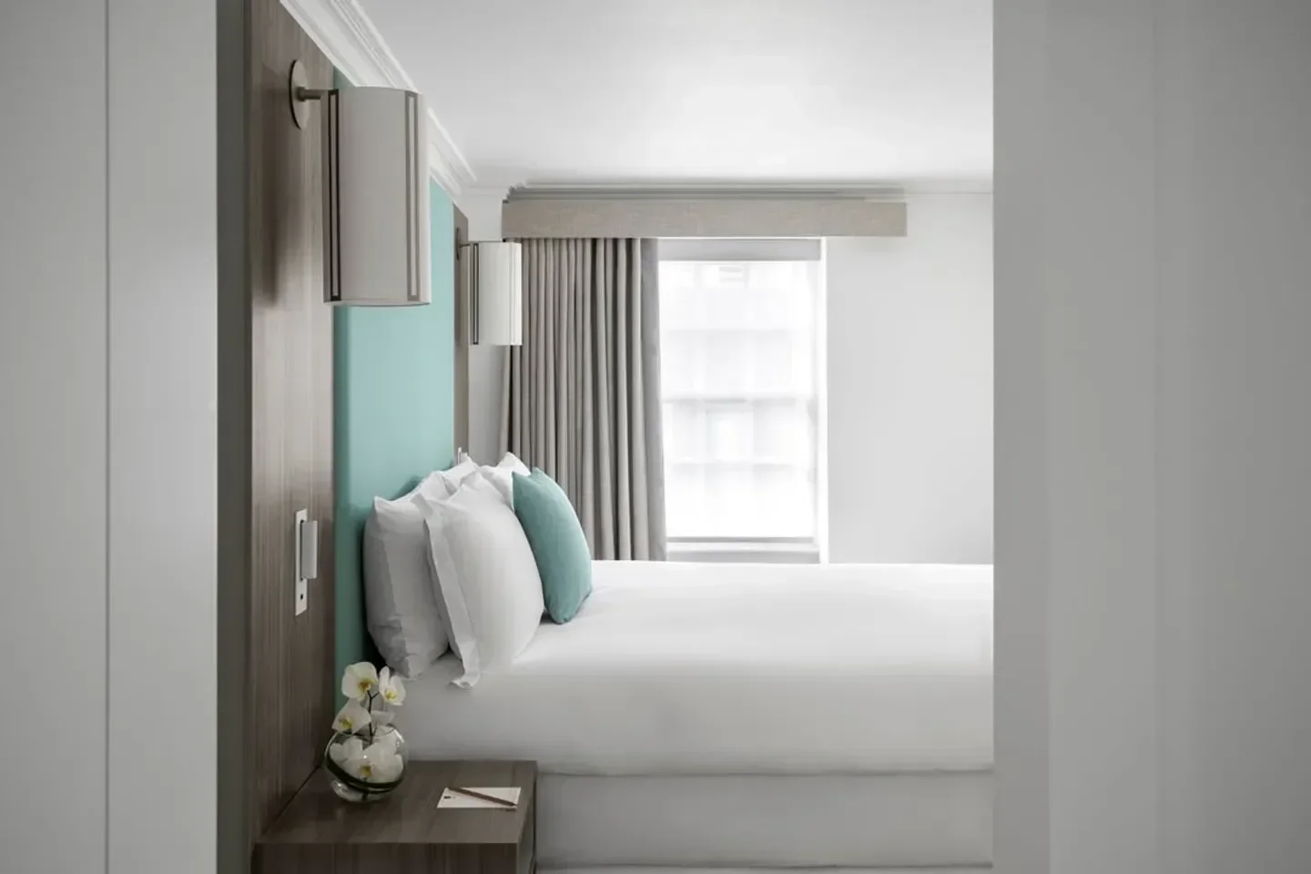 Stylish bedroom interior at COMO Metropolitan London hotel in London, featuring bright decor.