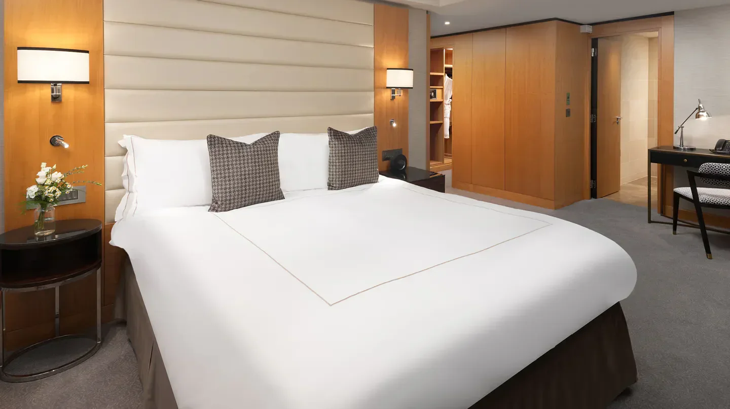 Cozy bedroom at the Conrad London St. James hotel in London, featuring a luxurious bed.