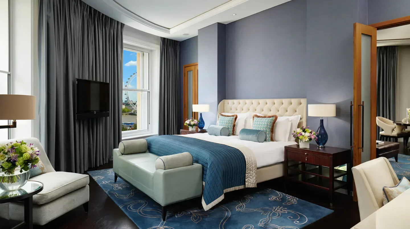 Elegant bedroom at Corinthia London hotel with London Eye view