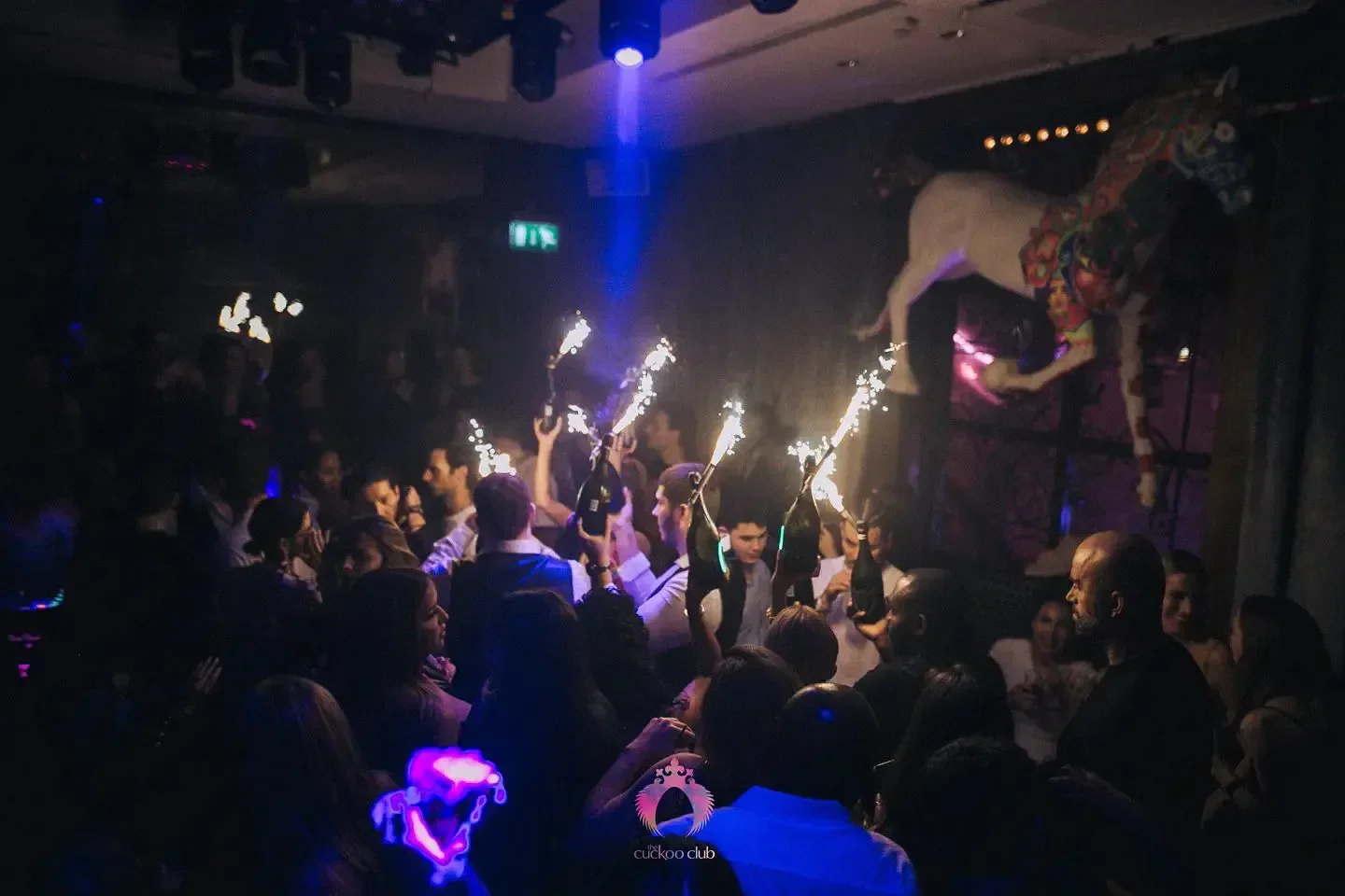 Party scene at Cuckoo Club London, with sparklers and crowd celebration.