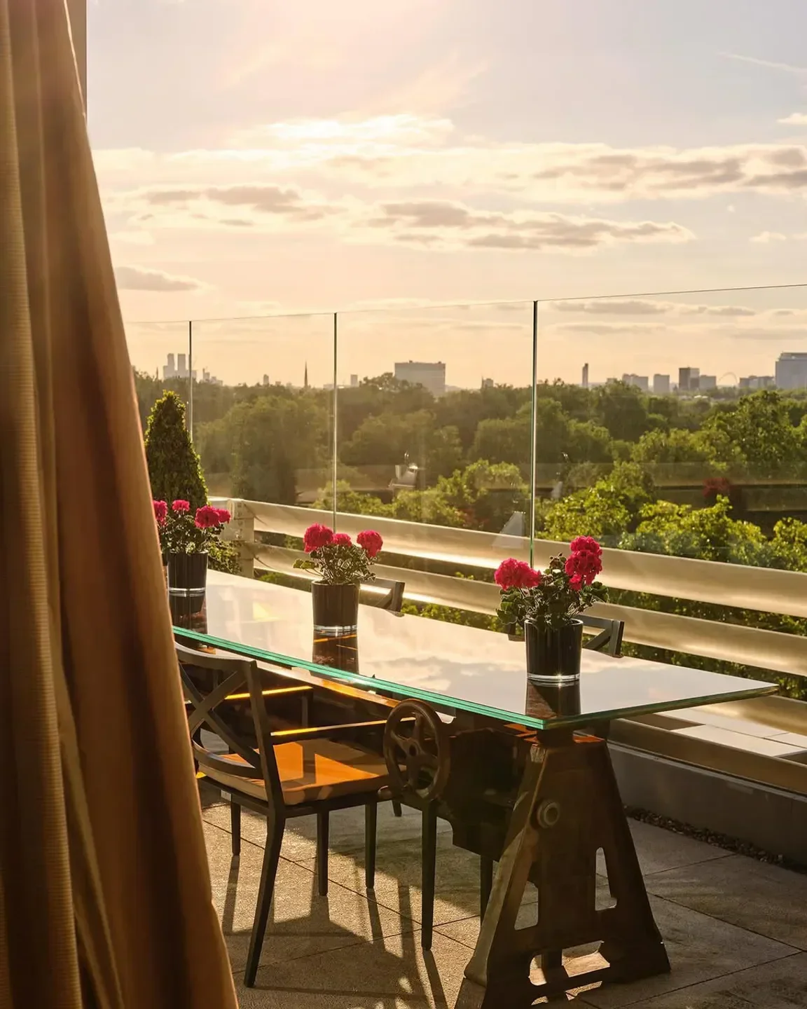 Outdoor dining at CUT at 45 Park Lane in London, with city views and floral accents.