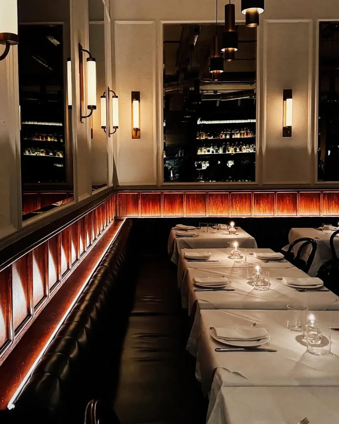 Elegant dining area at Dorian restaurant in London with warm lighting and tables.