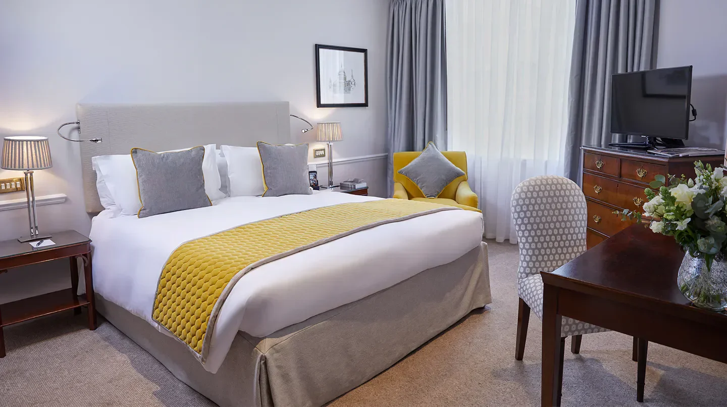 Elegant bedroom at DUKES LONDON hotel in London, featuring luxury decor and design.