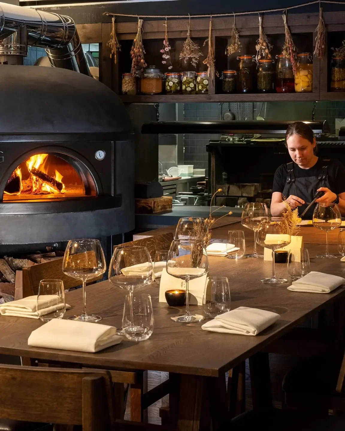 Cozy dining setting at Ekstedt at The Yard in London, featuring a wood-fired oven.
