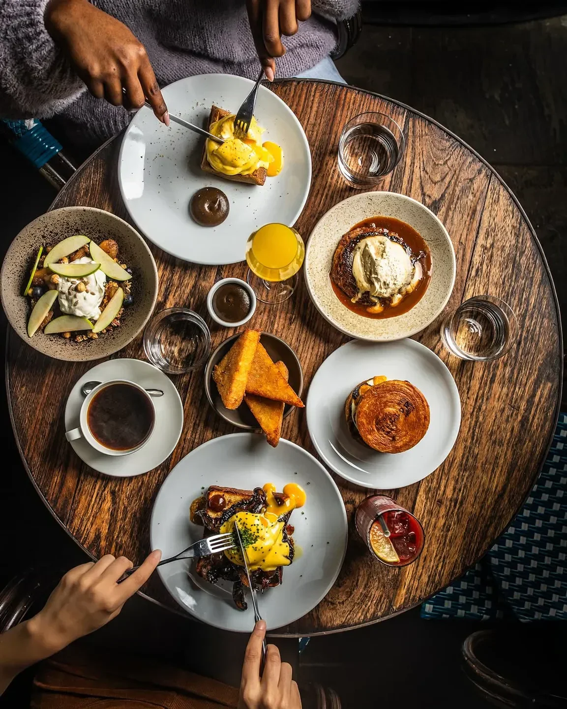 Delicious brunch at Fallow, London: eggs Benedict and various other plates.