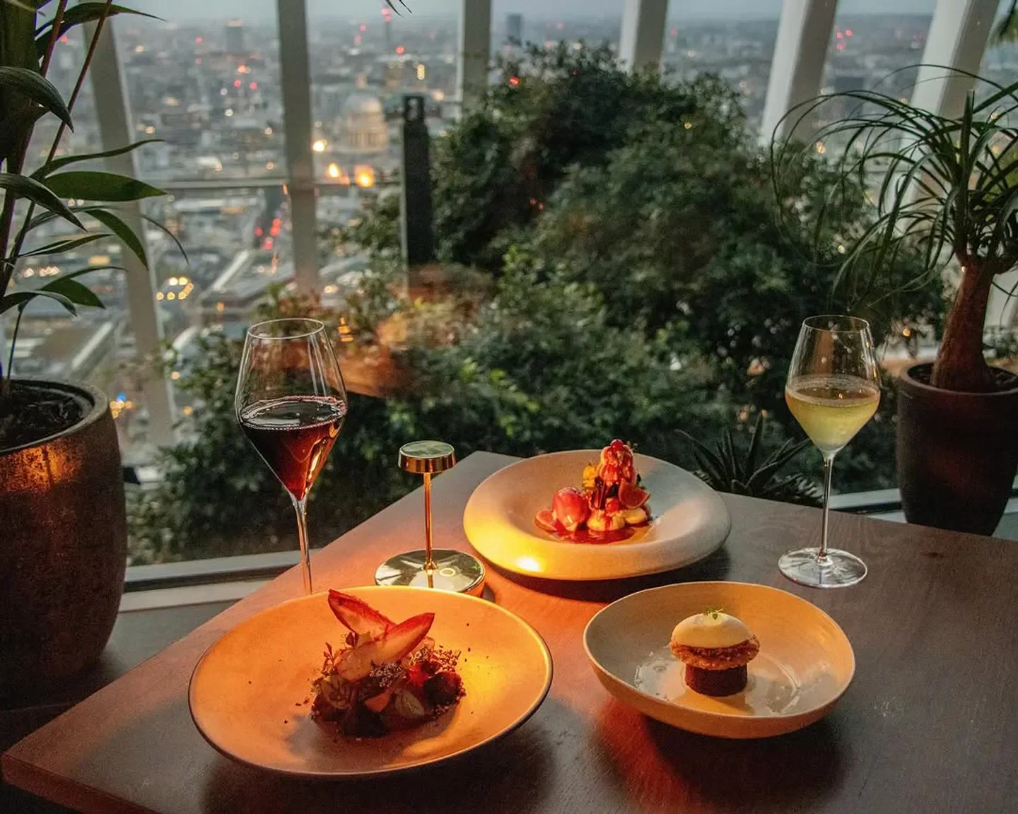 Fine dining with city views at Fenchurch restaurant, London. Wine and food on the table.
