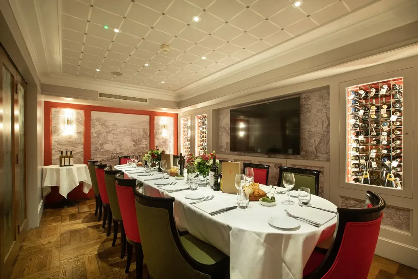 Elegant dining room at Franco's in London, featuring wine and a beautifully set table.