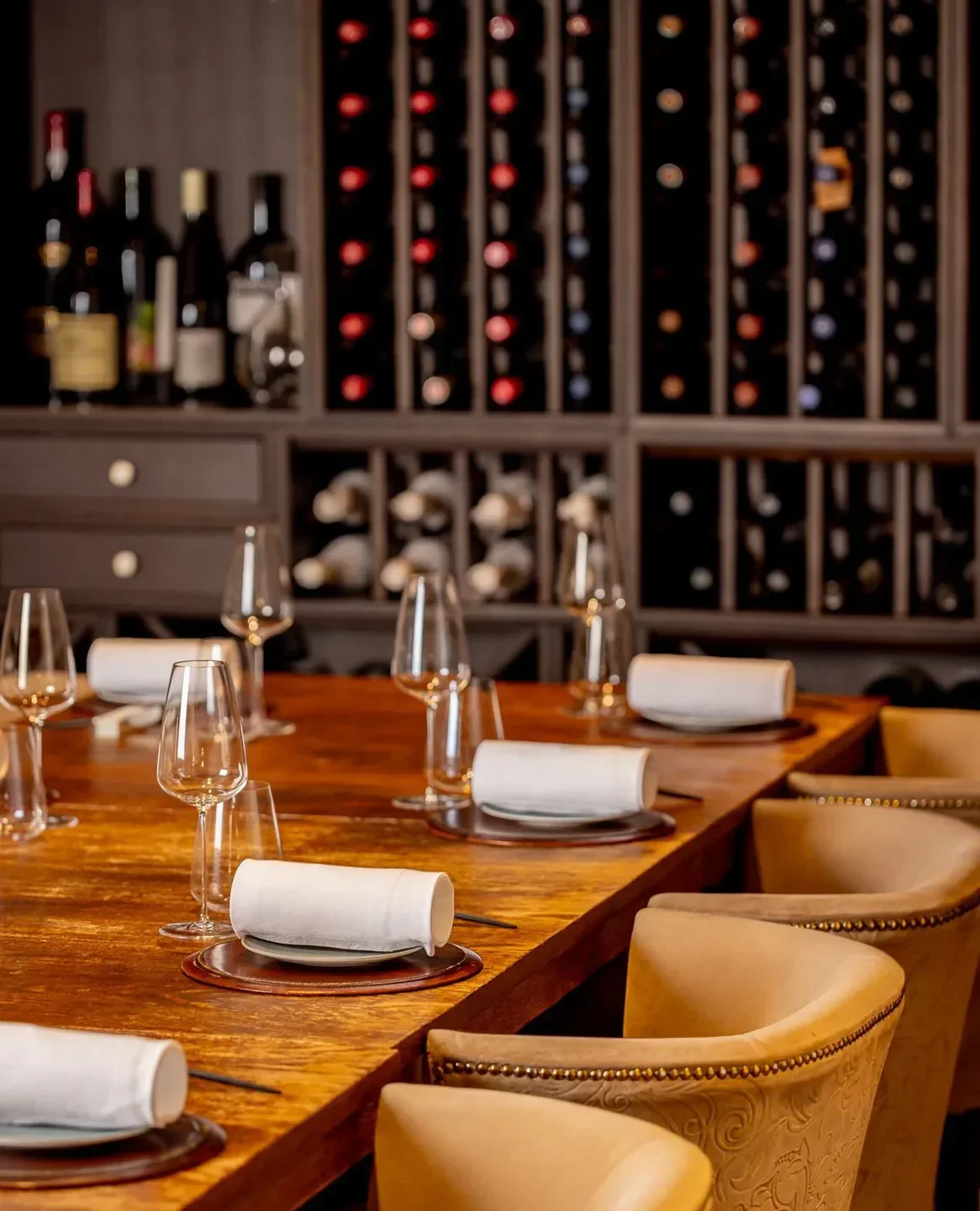 Frog by Adam Handling, London: elegant dining table set for guests with wine cellar backdrop.