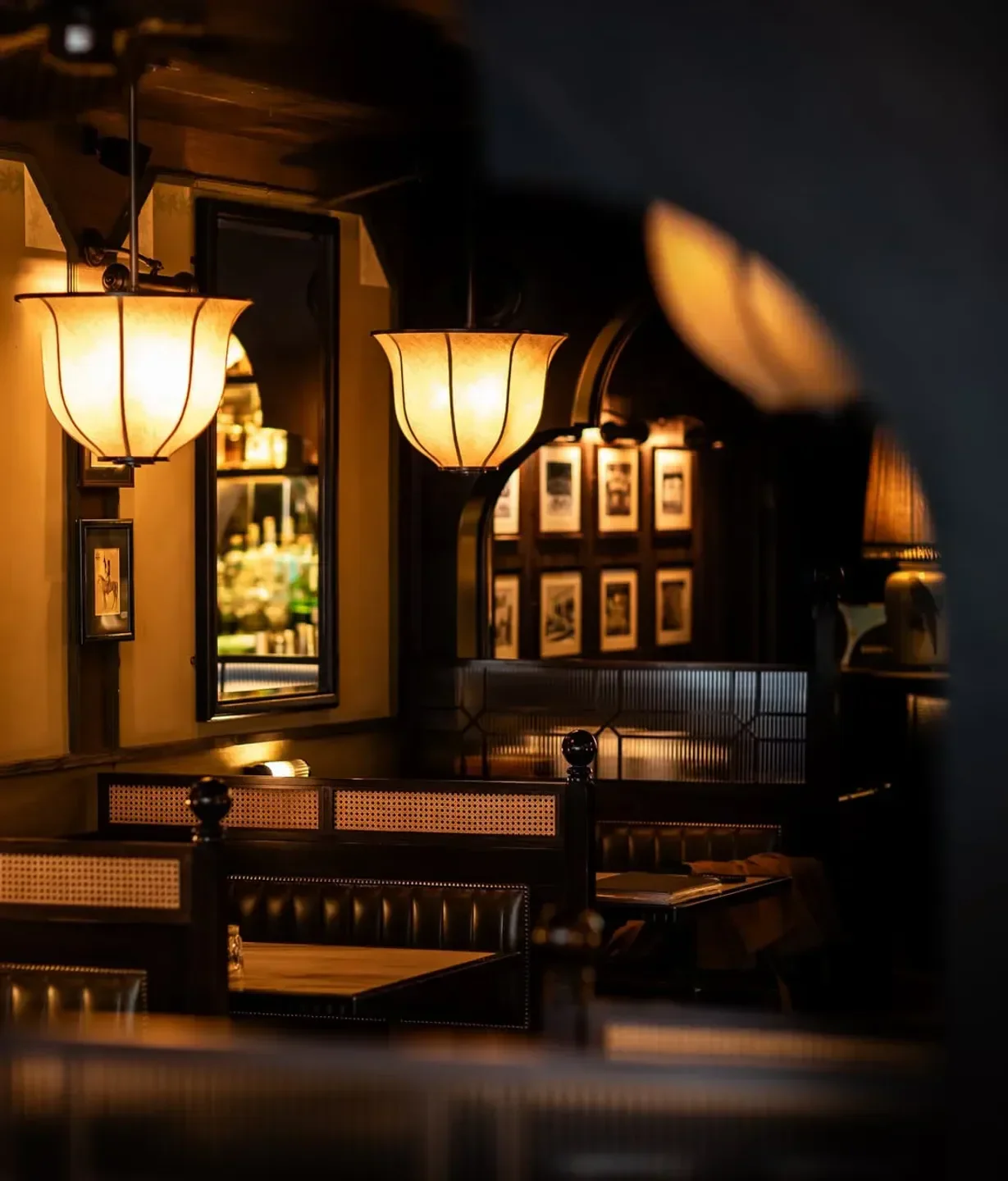 Cozy interior of Gymkhana restaurant in London, with warm lighting and booth seating.