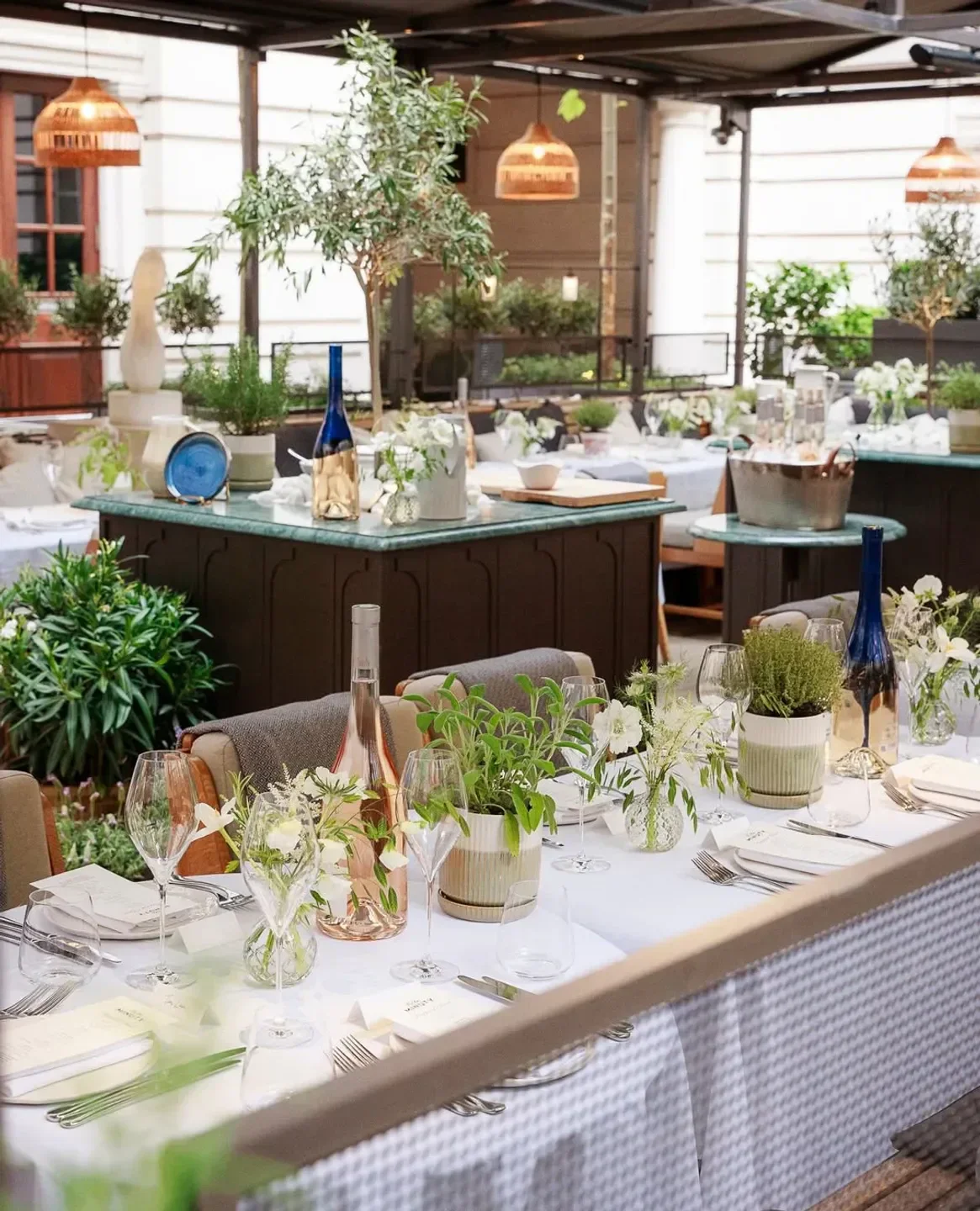 Holborn Dining Room, London: Outdoor dining table set with elegant decor and plants.