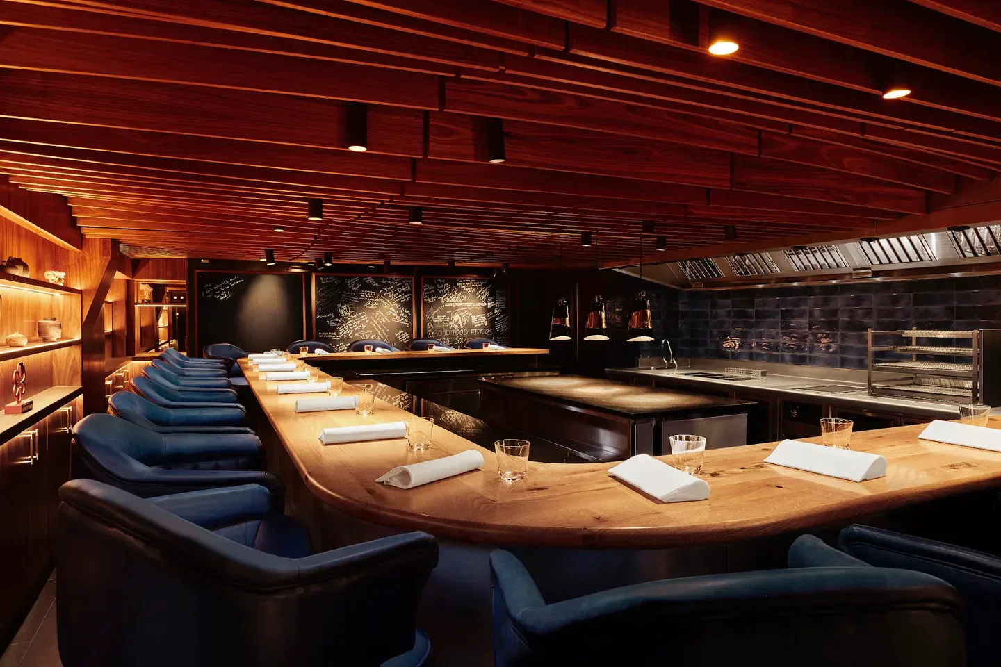 Elegant dining space at Kitchen Table restaurant in London, with wood and blue decor.