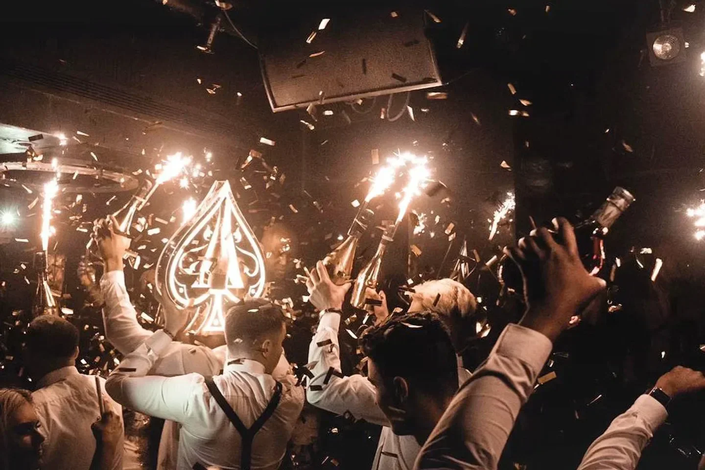 Champagne celebration at Libertine nightclub in London with confetti and sparklers.