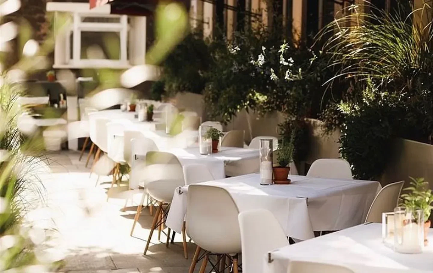Outdoor seating at Locanda Locatelli restaurant in London with white chairs and tables