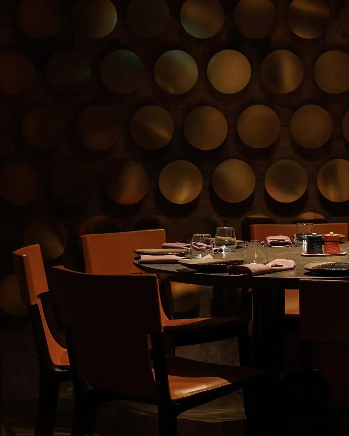 Cozy dining setting at Lusin restaurant in London with elegant wall decor