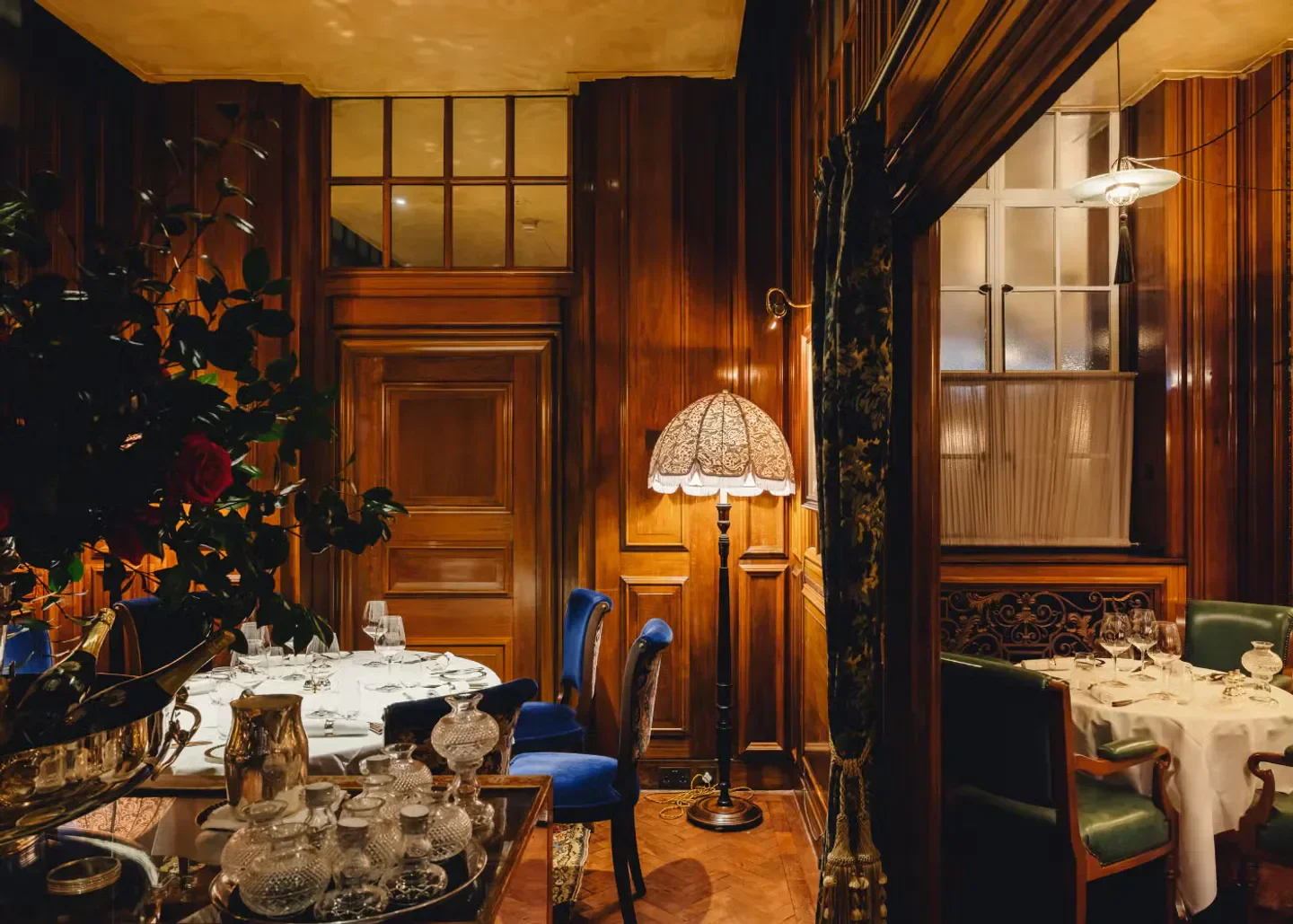 Cozy interior of Lutyens Grill in London, featuring wooden paneling and elegant dining setting.