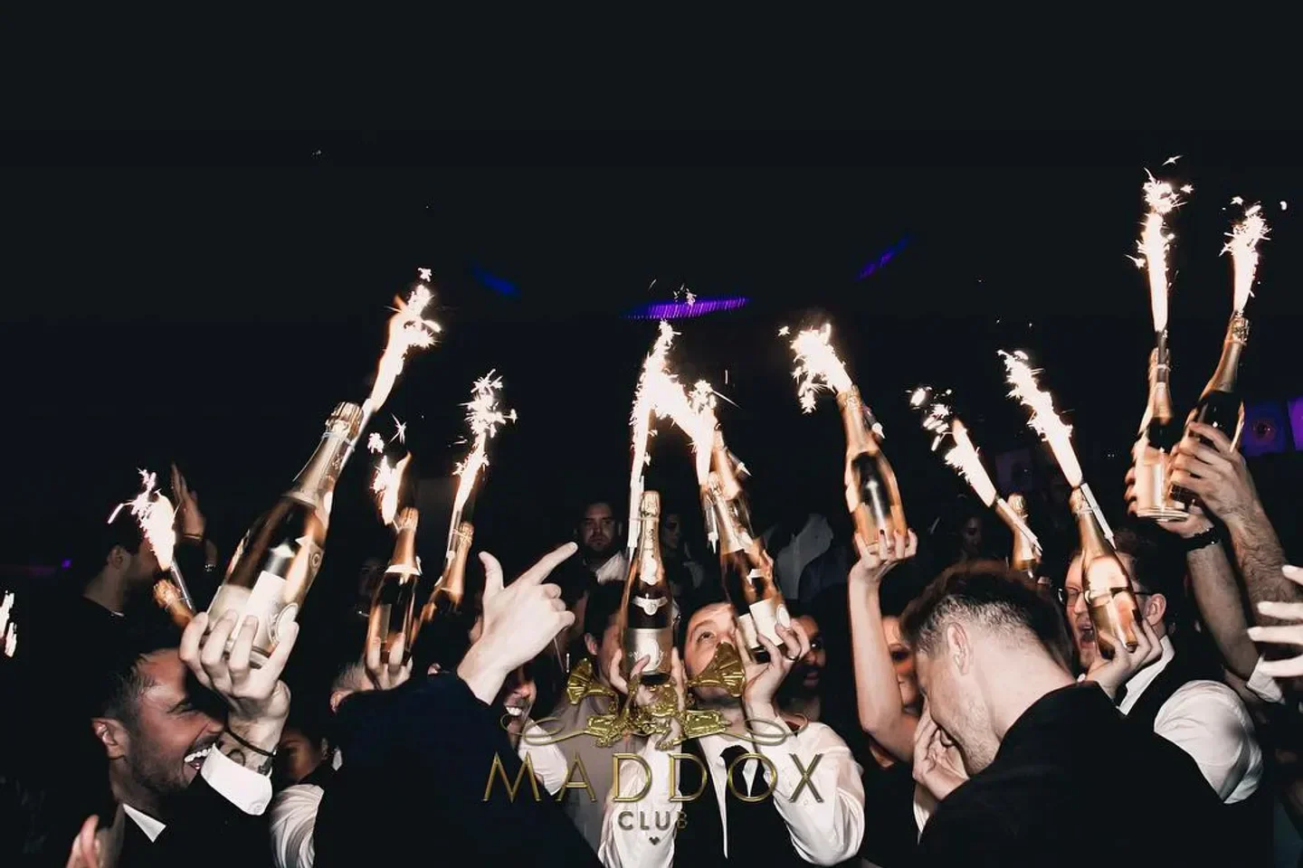 Champagne bottles with sparklers at Maddox Club in London, celebratory nightlife scene