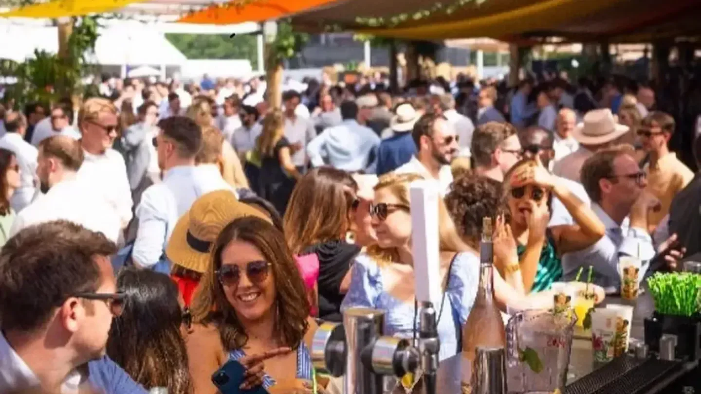 Crowded outdoor scene at Mahiki London, people enjoying drinks and socializing.
