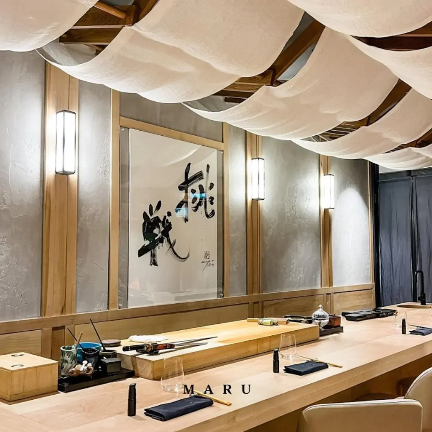 Interior of MARU restaurant in London, with a sushi counter and artistic ceiling.