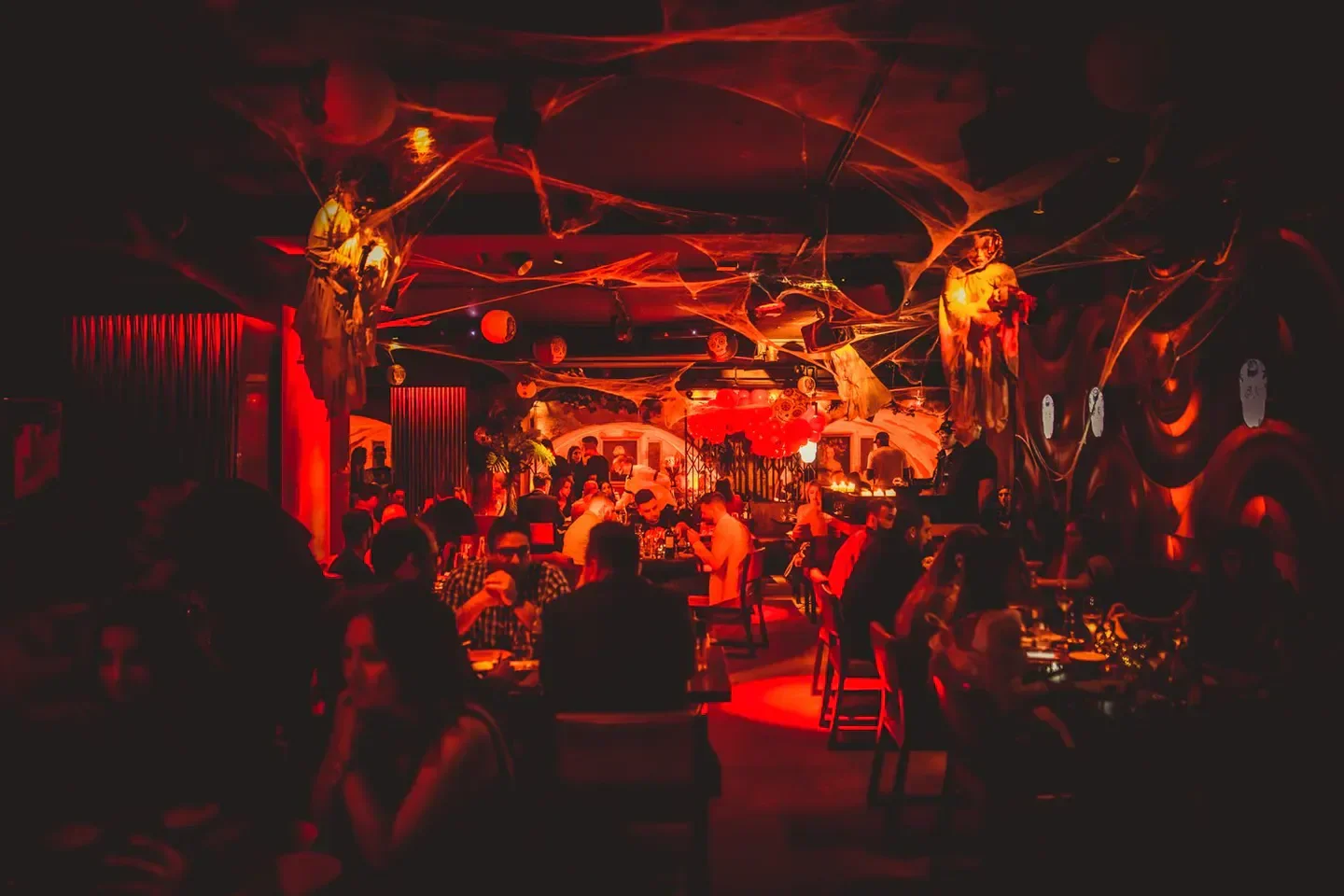 Interior of MNKY HSE London nightclub with spooky decorations and lively atmosphere.
