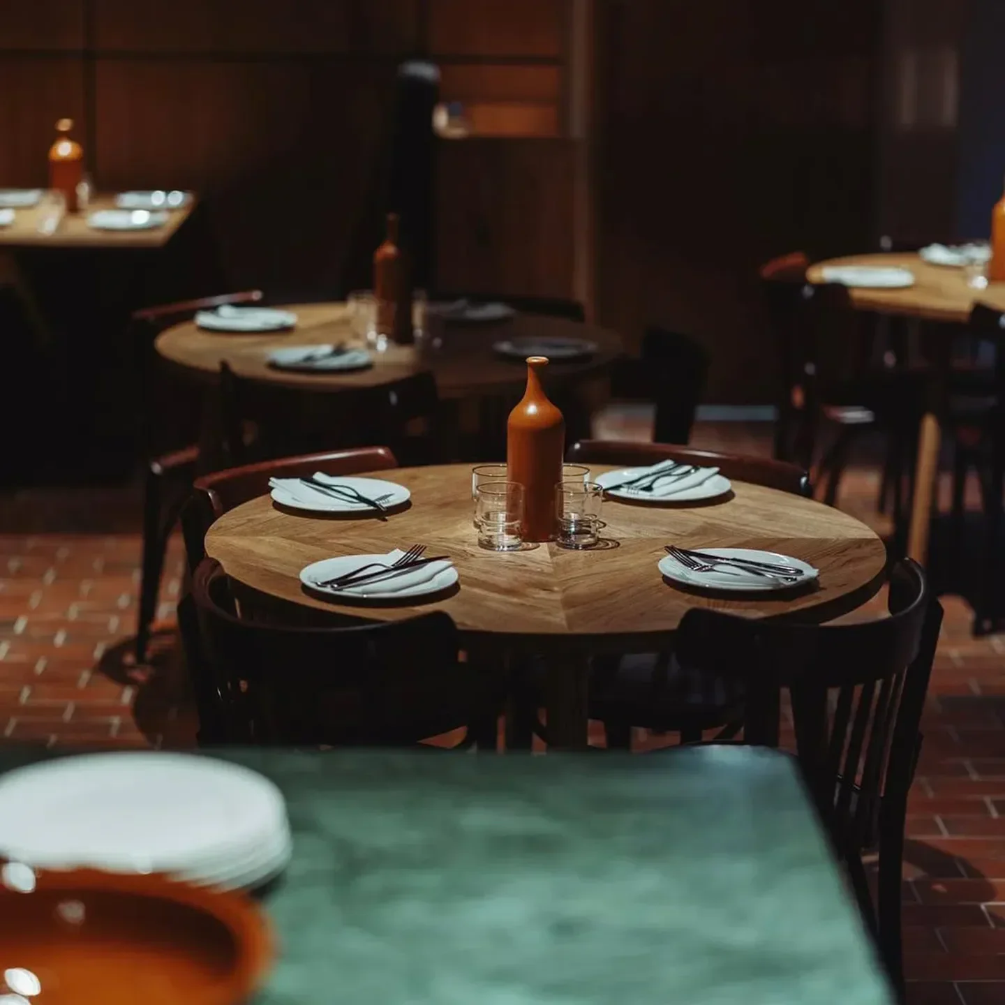 Cozy dining area at Mountain restaurant in London, featuring wooden tables and elegant setting.