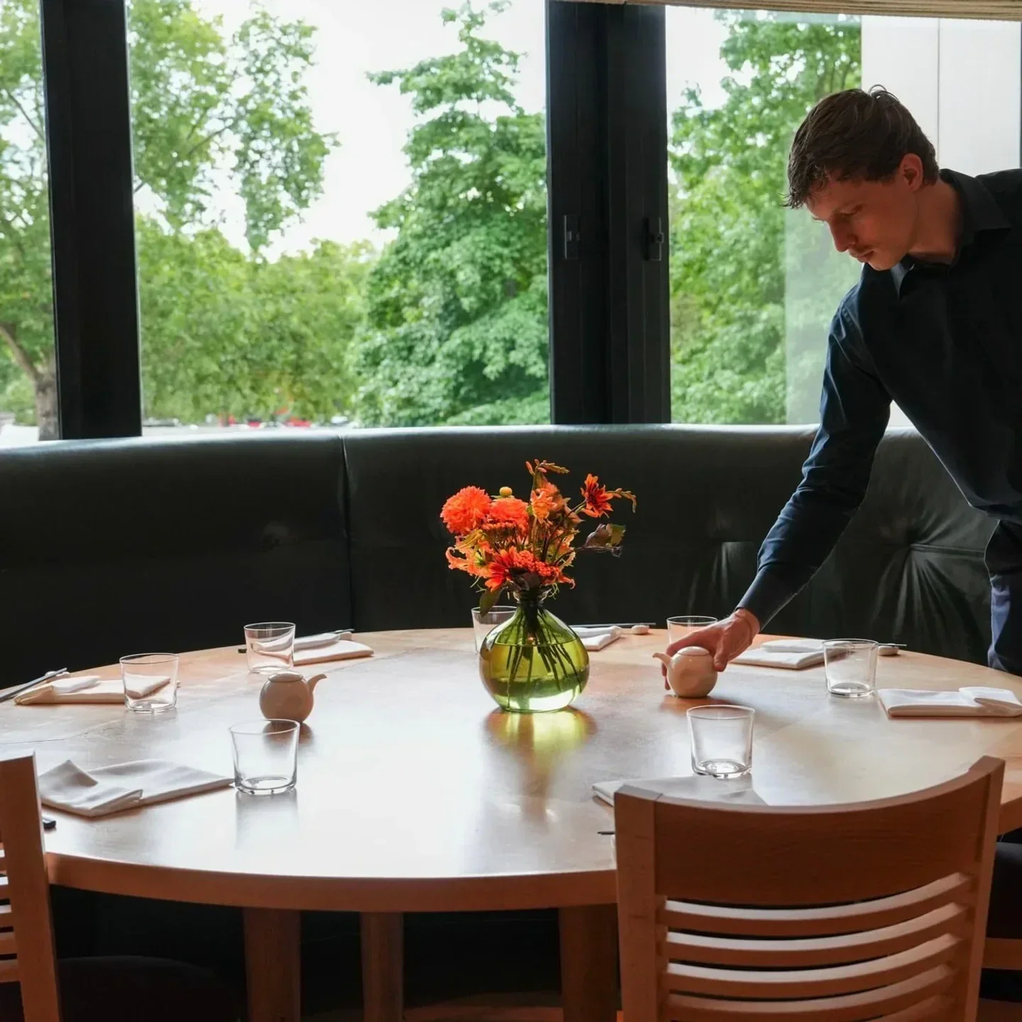 Table setting at Nobu London restaurant, with a waiter arranging details for guests.