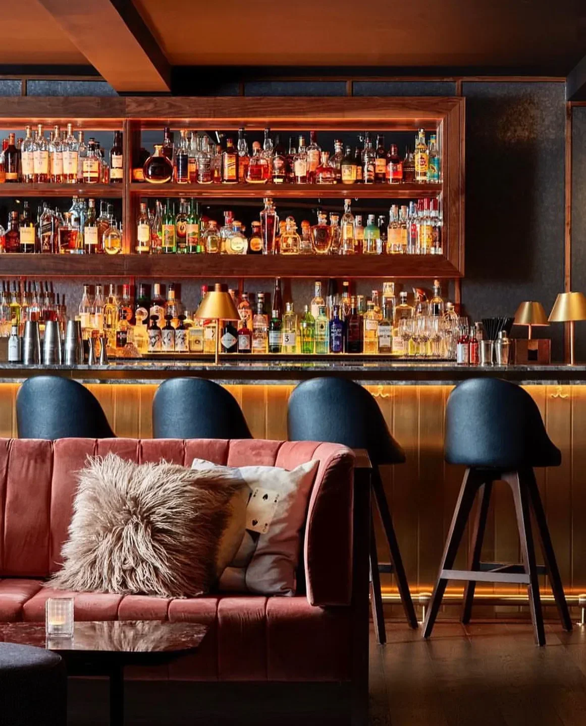 Interior of Nolita Social Bar in London, showcasing a stylish bar with plush seating.