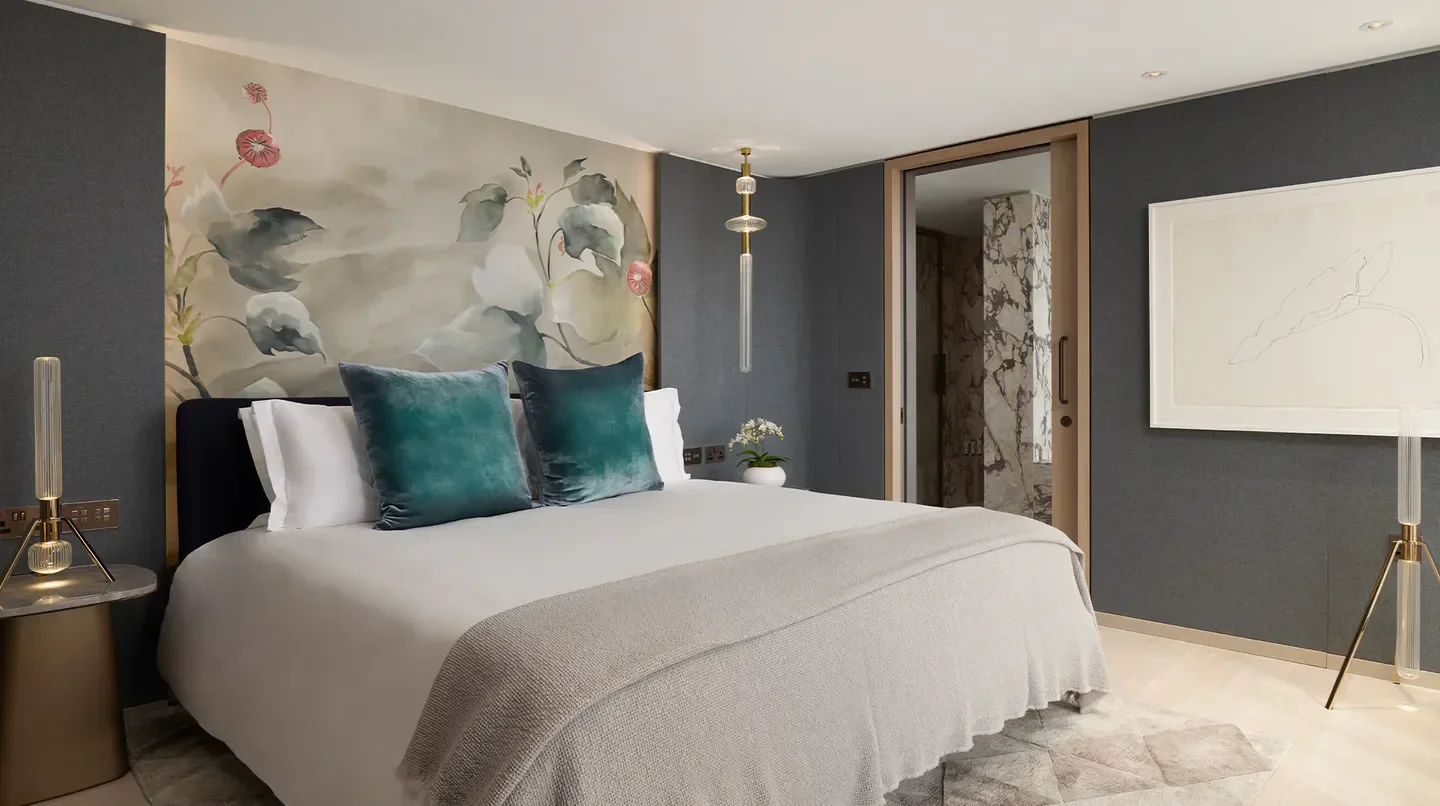 Stylish bedroom at Pan Pacific London hotel, featuring floral mural and luxury design in London