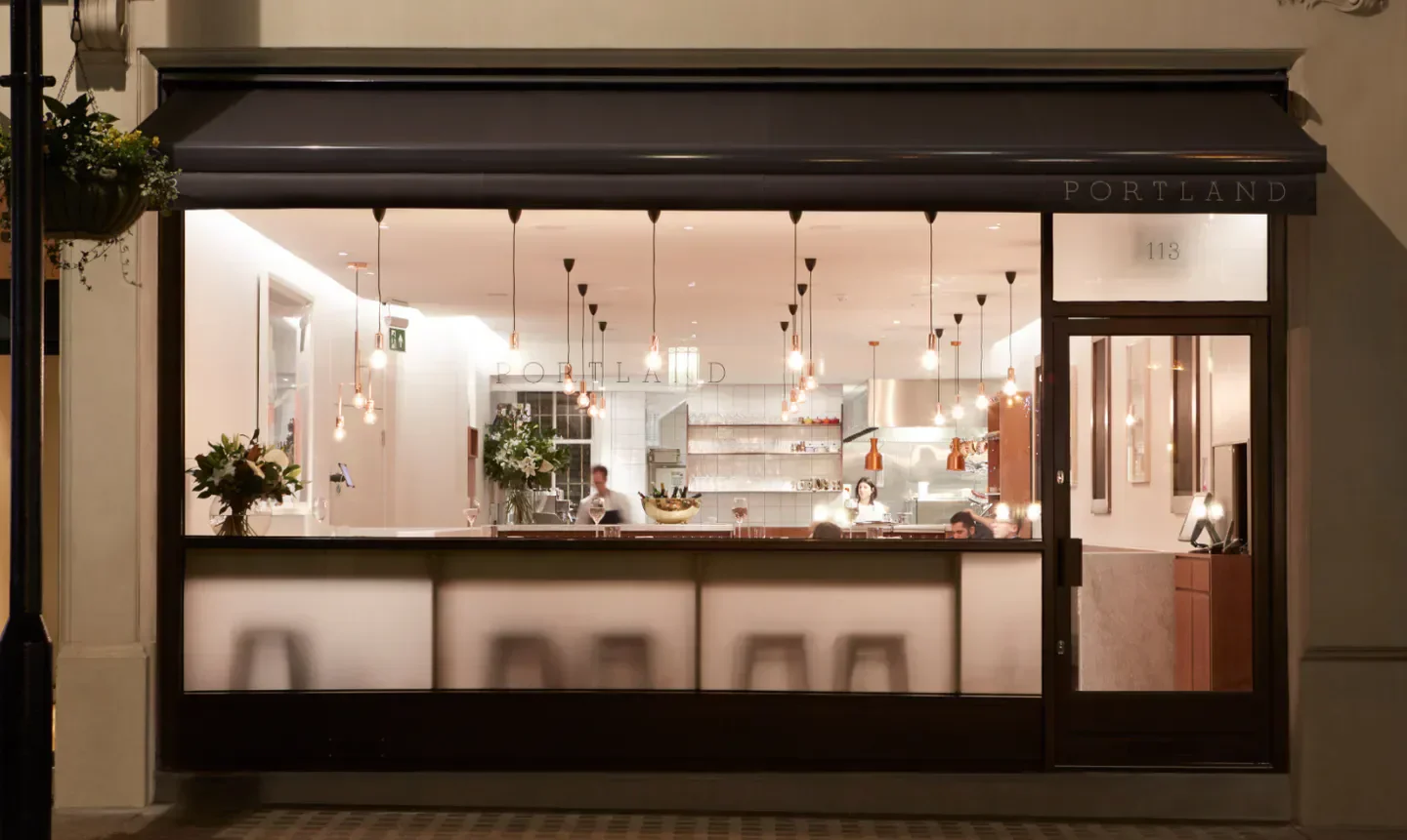 Portland restaurant in London, illuminated interior showcasing modern design and elegant decor.