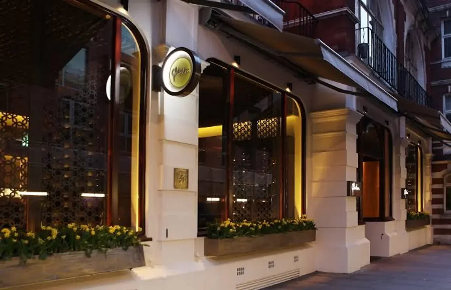 Exterior view of Quilon restaurant in London with elegant architecture and signage.