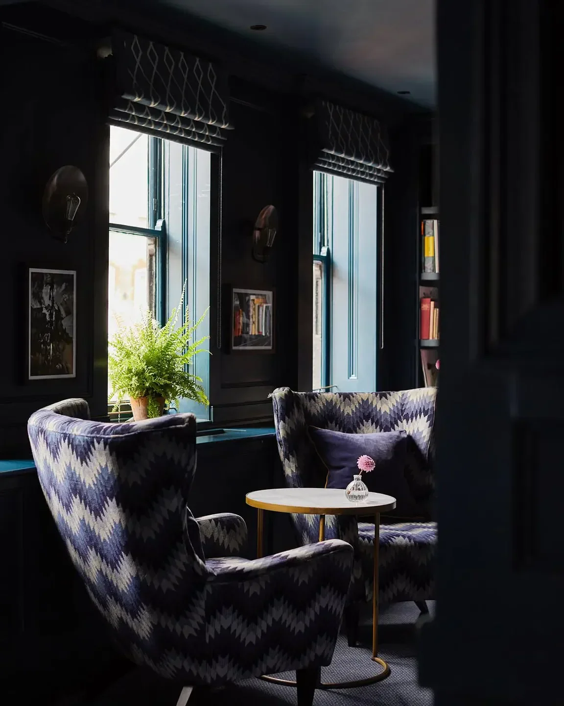 Elegant seating area at Quo Vadis restaurant in London with patterned chairs and small table