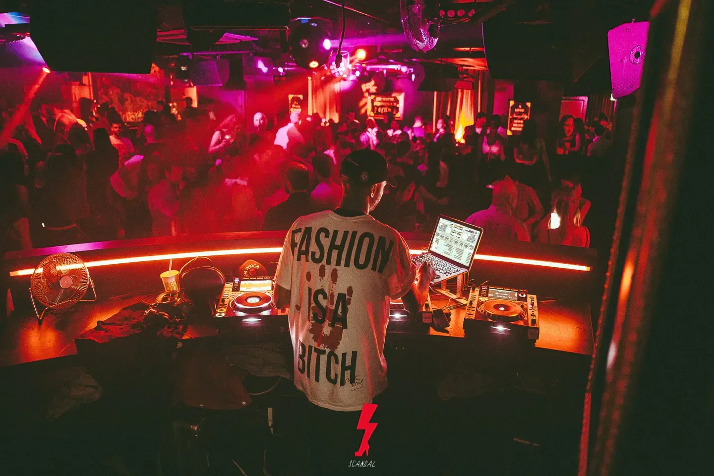 DJ performing at Scandal nightclub in London with a crowded dance floor