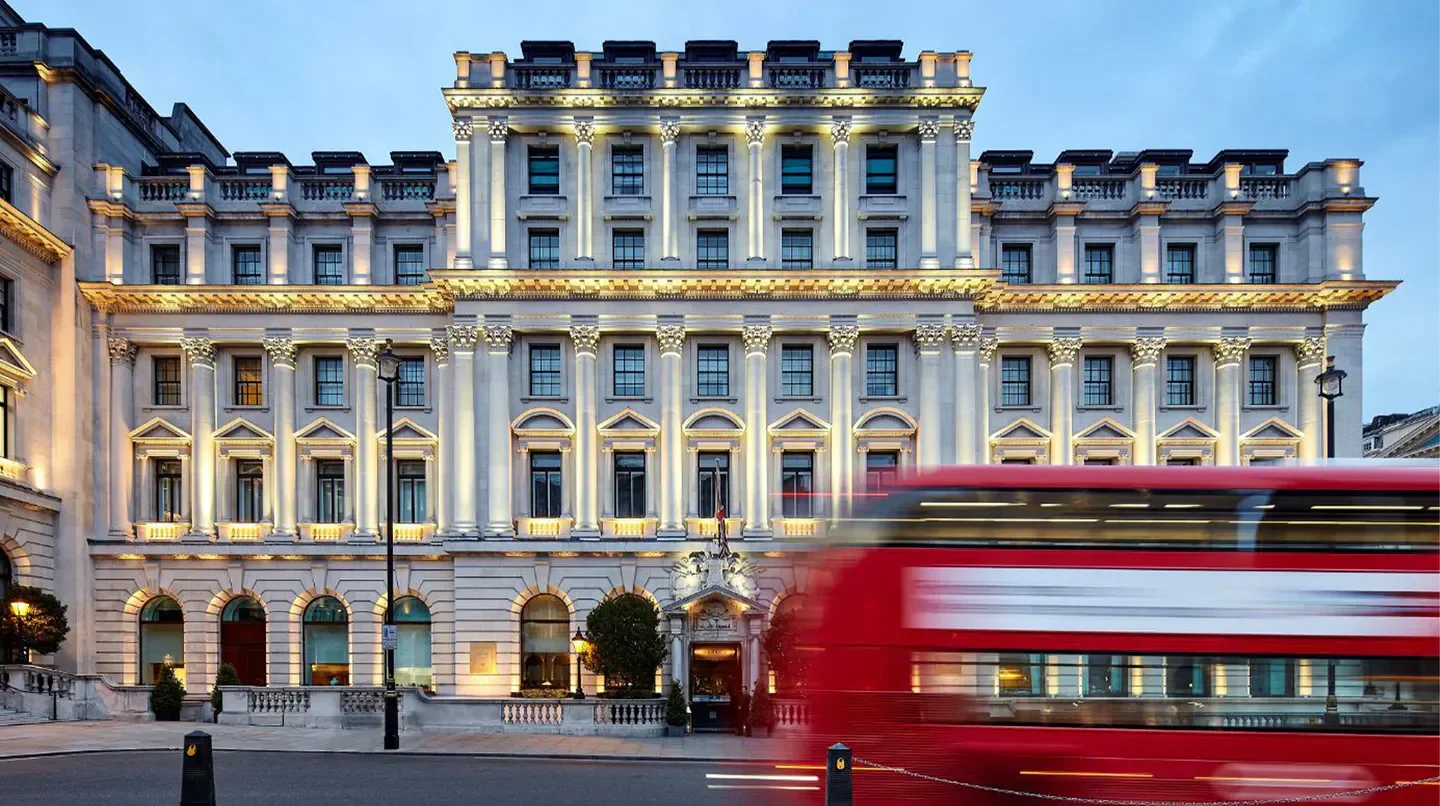 Sofitel London St James exterior with iconic red bus in London, UK.
