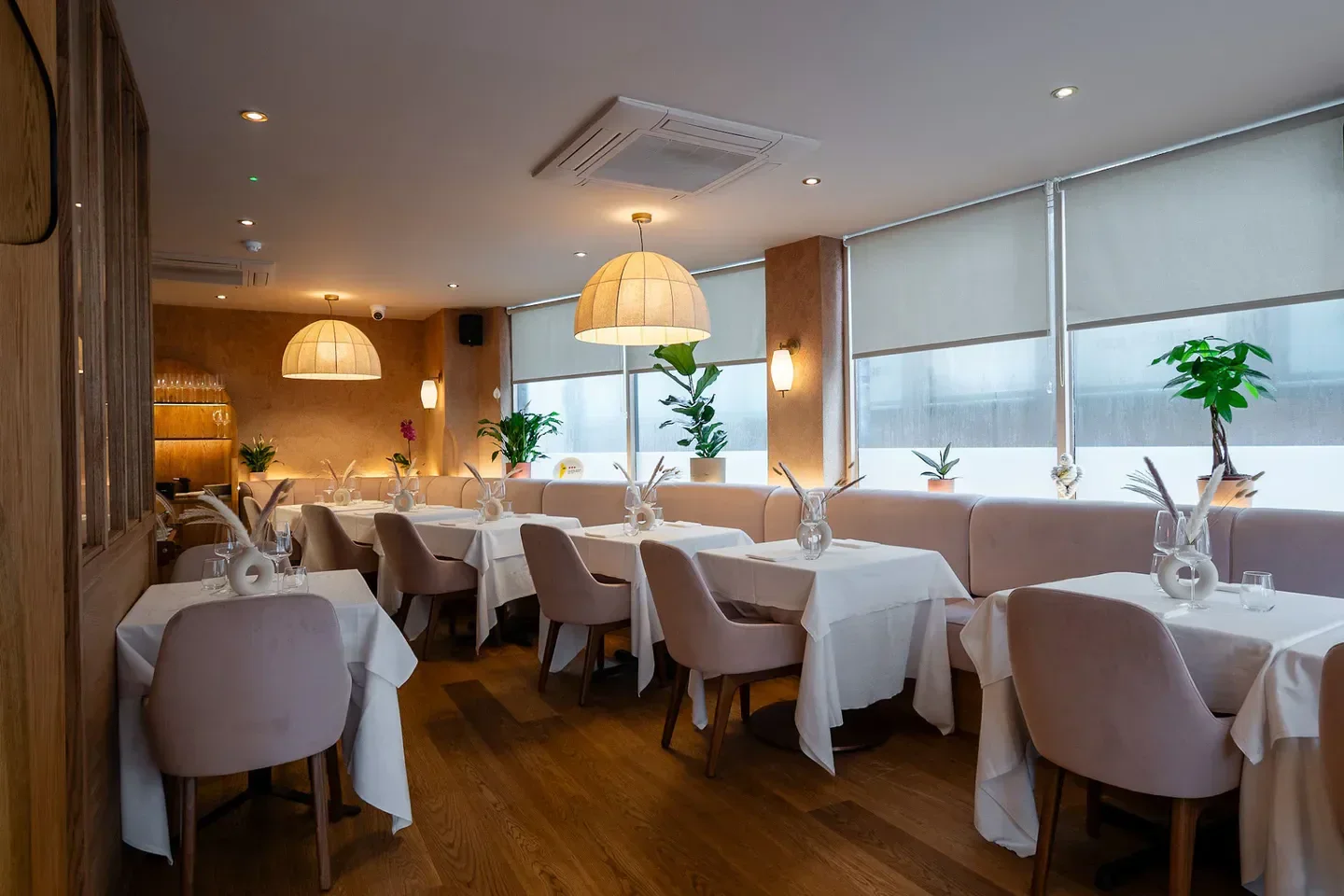 Interior of SOLA Soho restaurant in London, featuring stylish tables and decor.