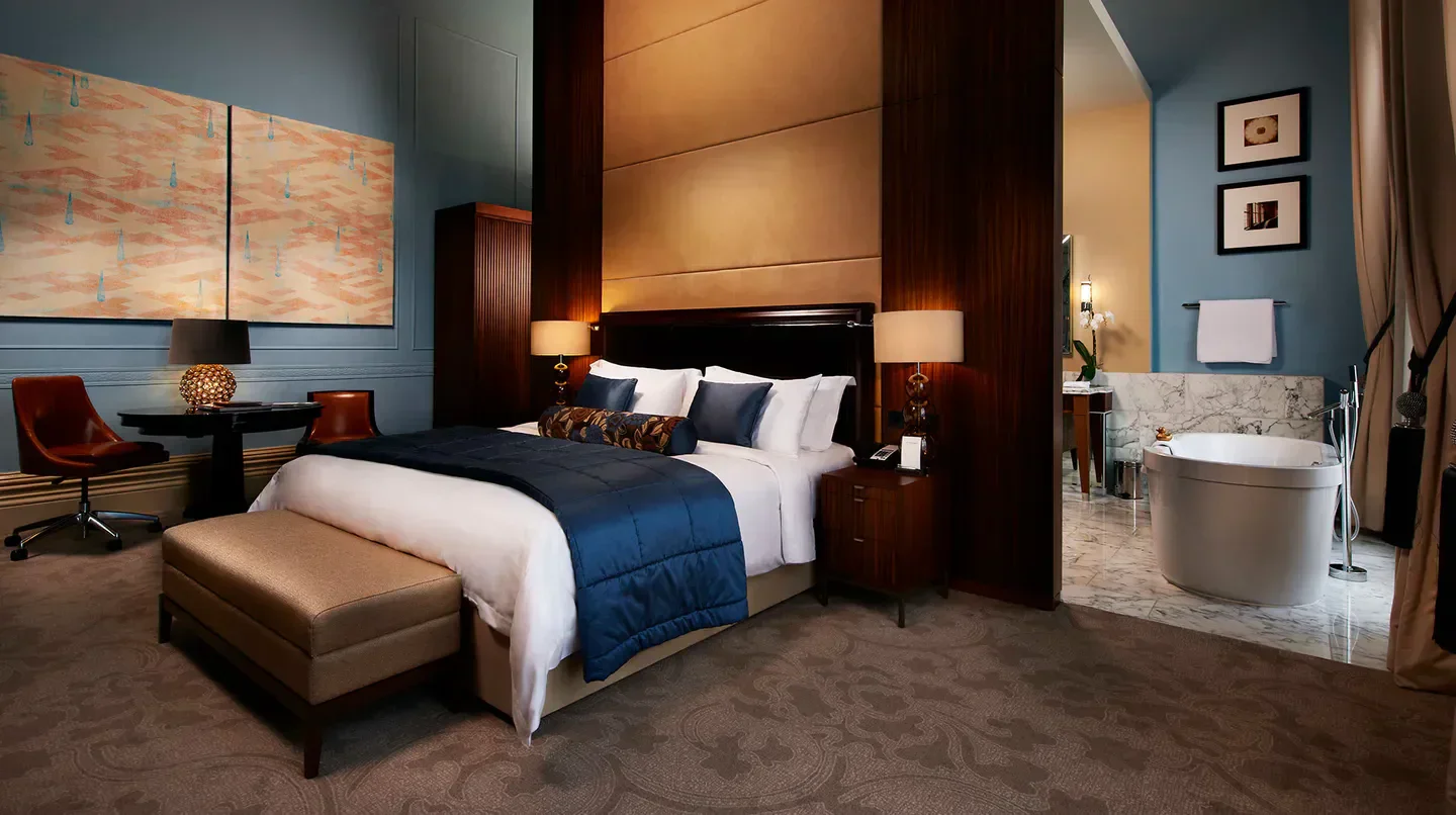 Elegant bedroom at St. Pancras Renaissance London Hotel with a luxurious ensuite bathroom