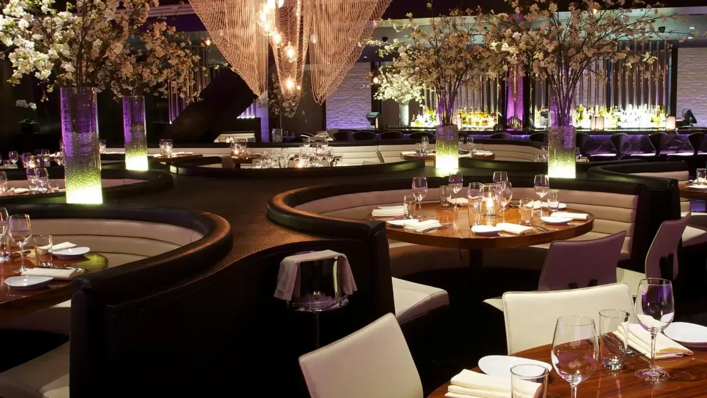 STK London's stylish interior with elegant seating and floral decor in a modern restaurant setting.