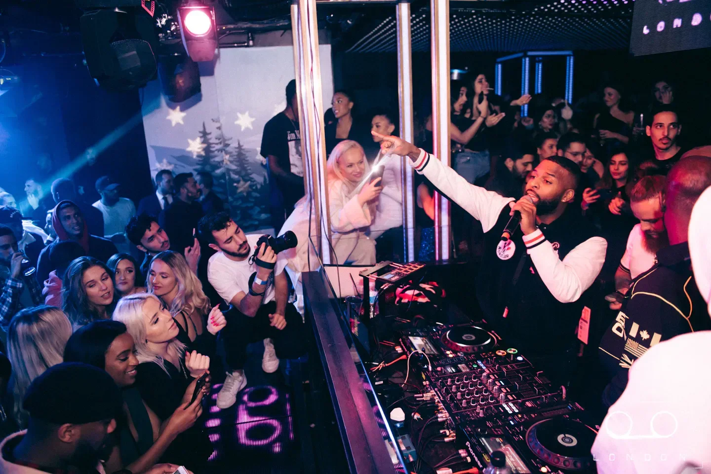 Energetic performer at Tape nightclub in London, captivating the audience with music.