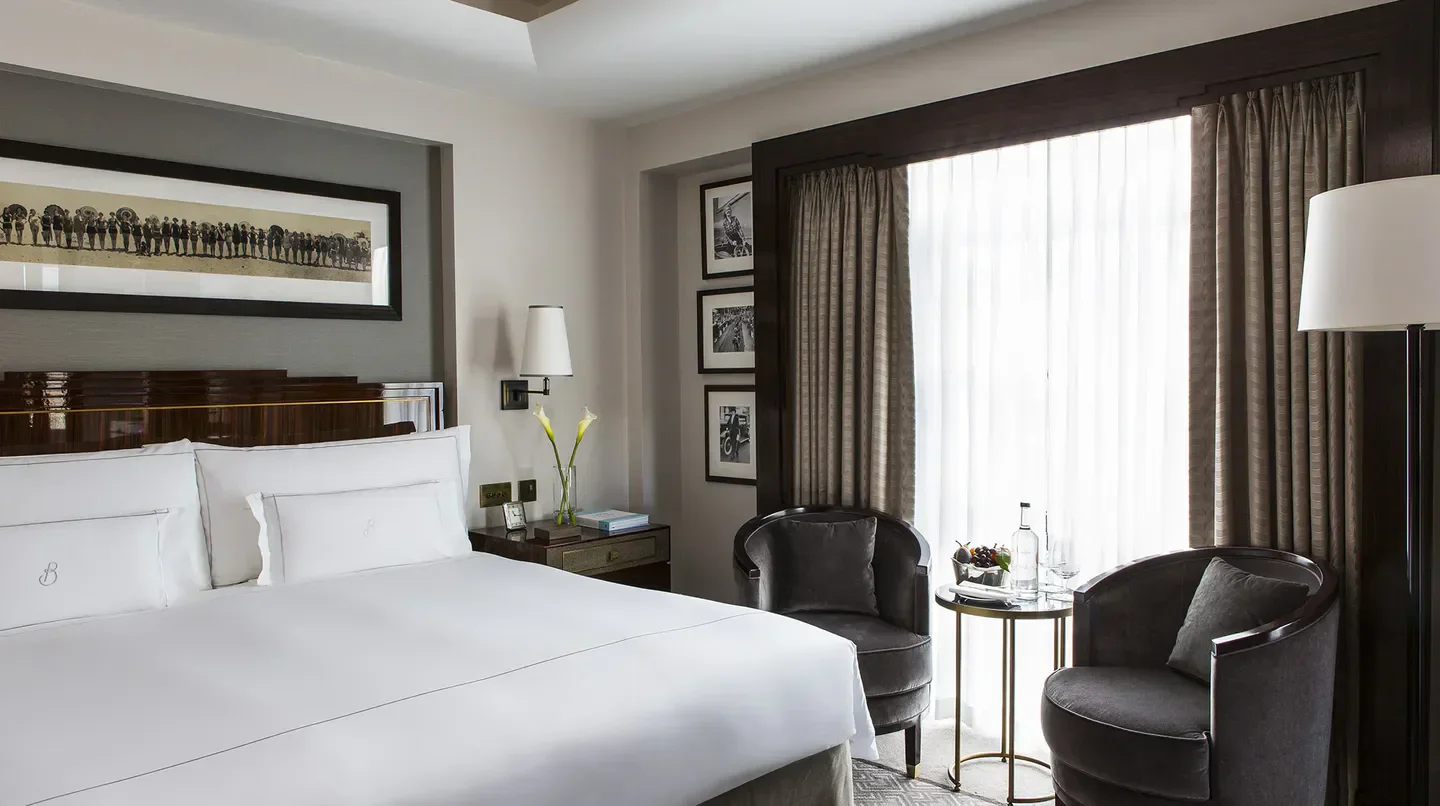 Elegant bedroom at The Beaumont hotel in London, featuring a luxurious interior.