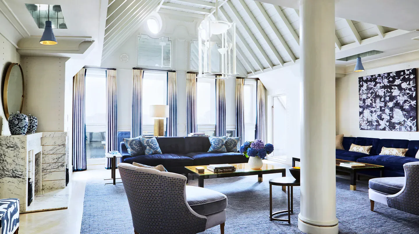 Elegant living room in The Connaught hotel, London, featuring blue accents and stylish decor.