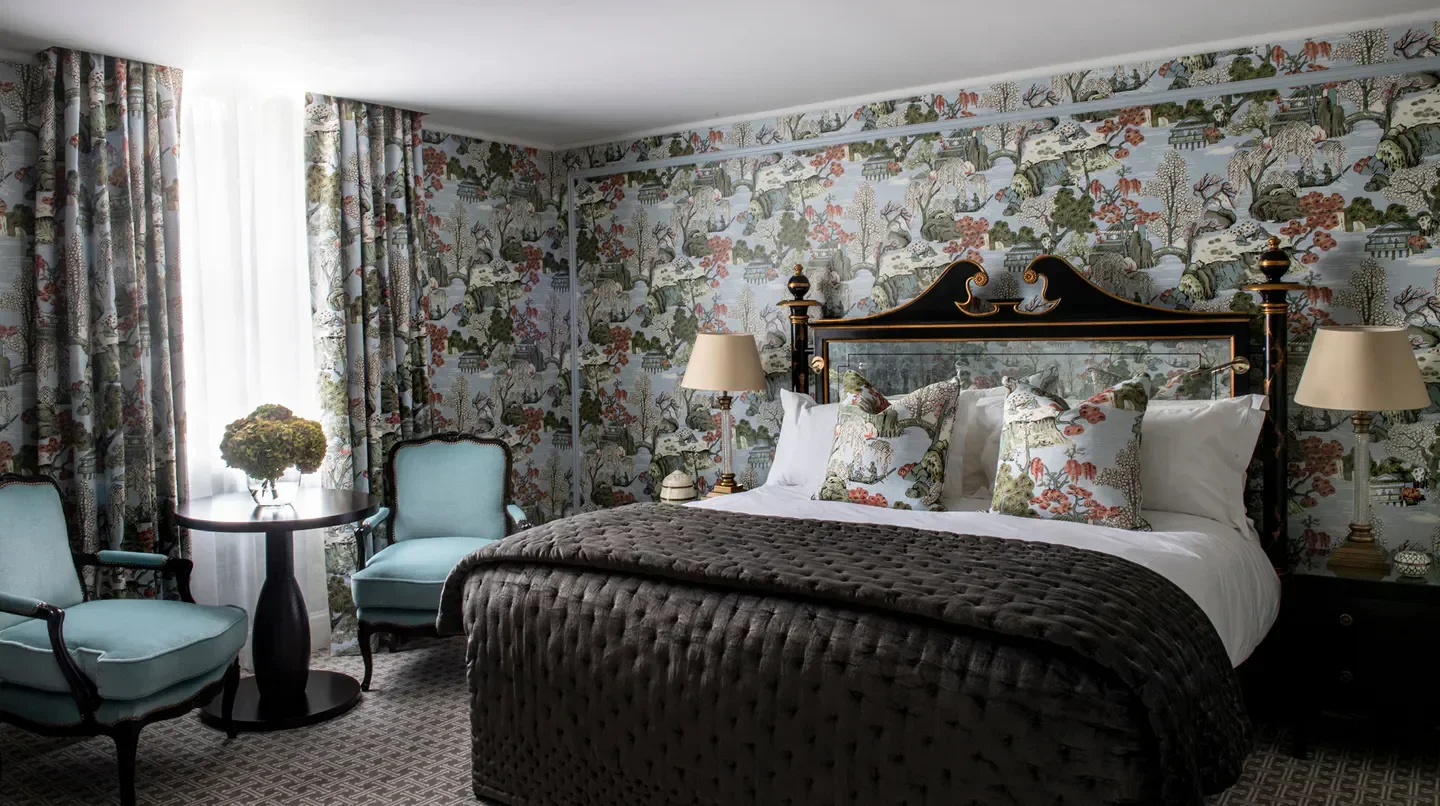 Elegant bedroom at The Kensington hotel in London, featuring unique wallpaper and decor.