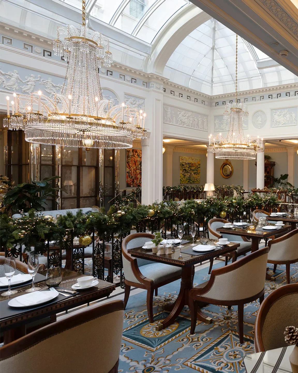 Elegant dining room at The Lanesborough Grill in London, featuring chandeliers and decorated tables.